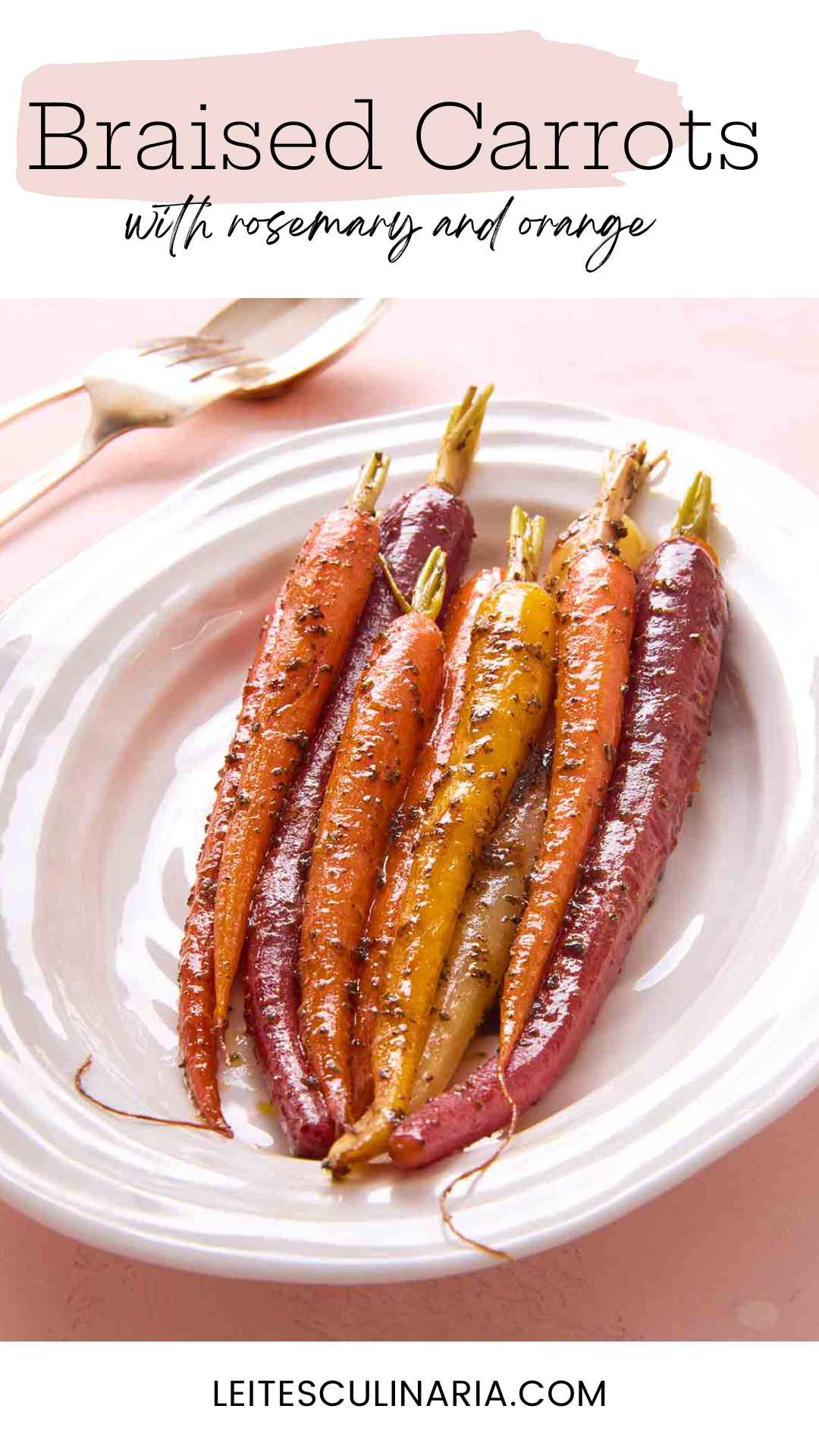 Nine colorful braised carrots on a white platter.