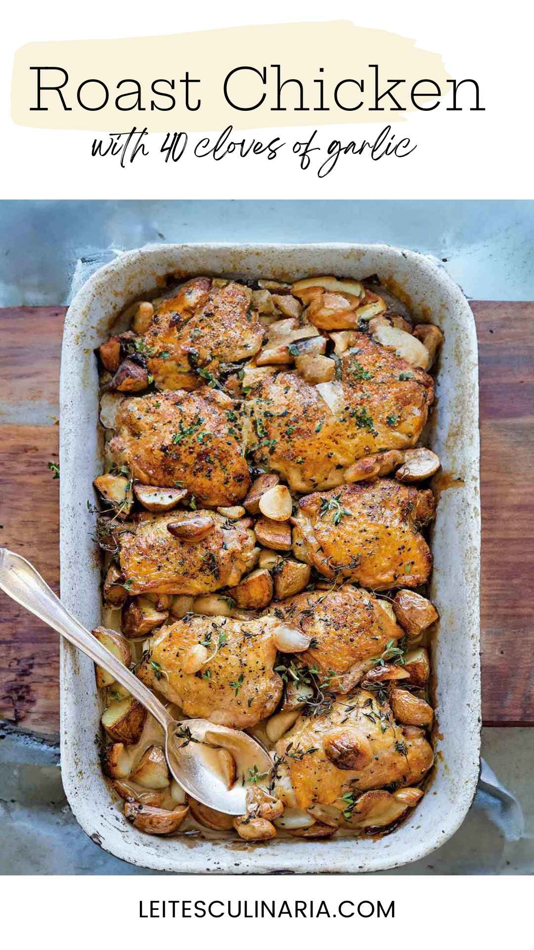 A roasting pan filled with chicken thighs, cloves of caramelized garlic, and sprigs of fresh thyme.