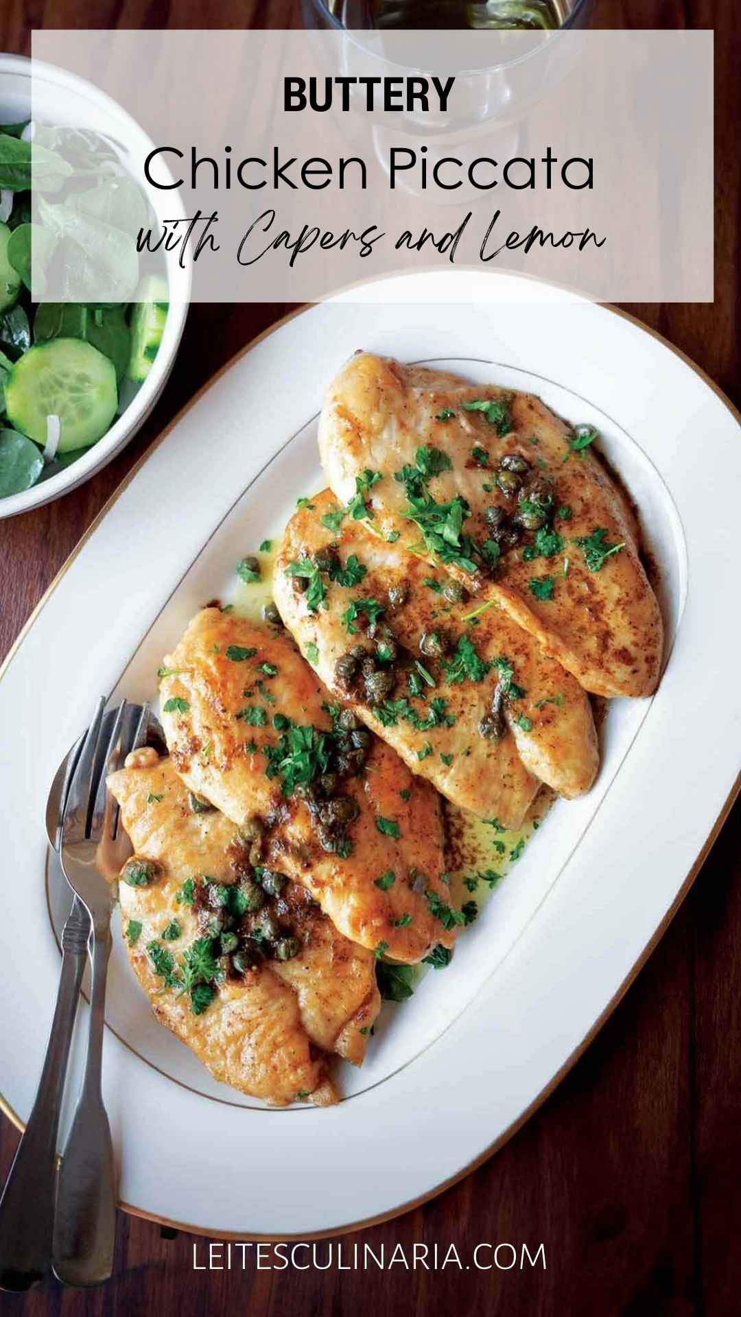 Four chicken cutlets topped with capers, parsley, and butter sauce on a white oval platter.