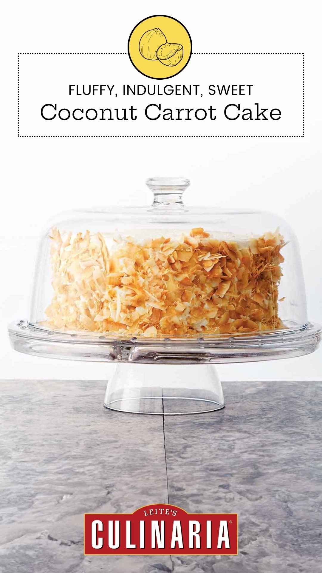 A carrot cake covered in toasted coconut flakes on a glass cake stand, covered with a glass dome.