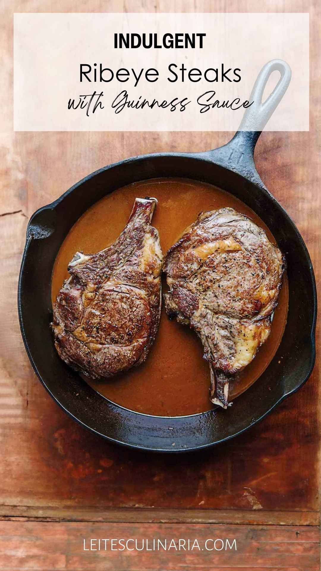 Two seared ribeye steaks in a Guinness beer sauce in a cast iron skillet.
