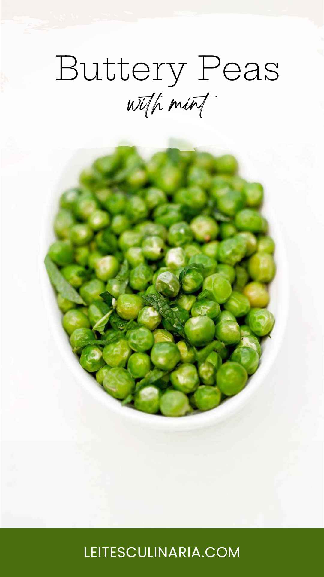 A bowl of fresh peas garnished with torn mint leaves.