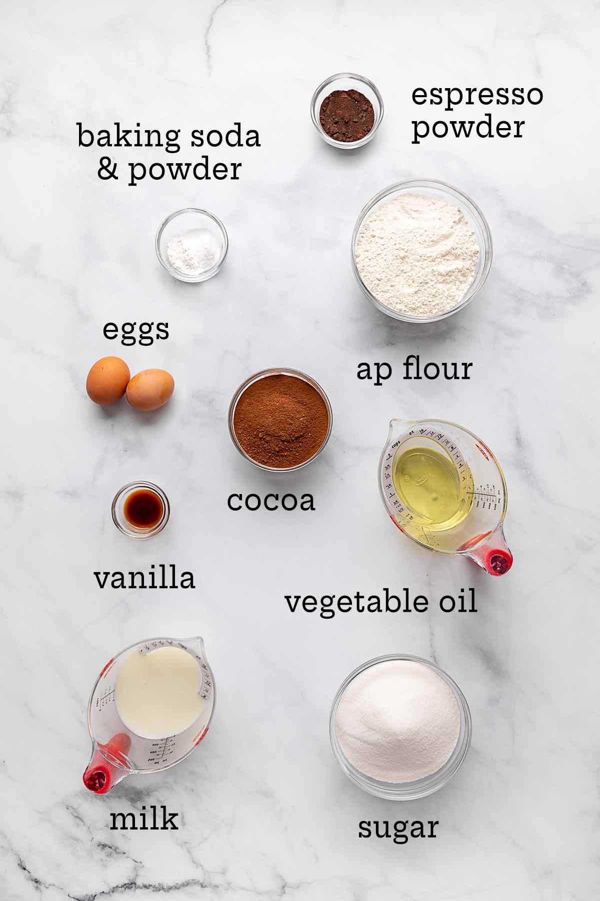 Ingredients for Hershey's chocolate cake--flour, sugar, cocoa, oil, milk, vanilla, eggs, baking soda and powder, and espresso.