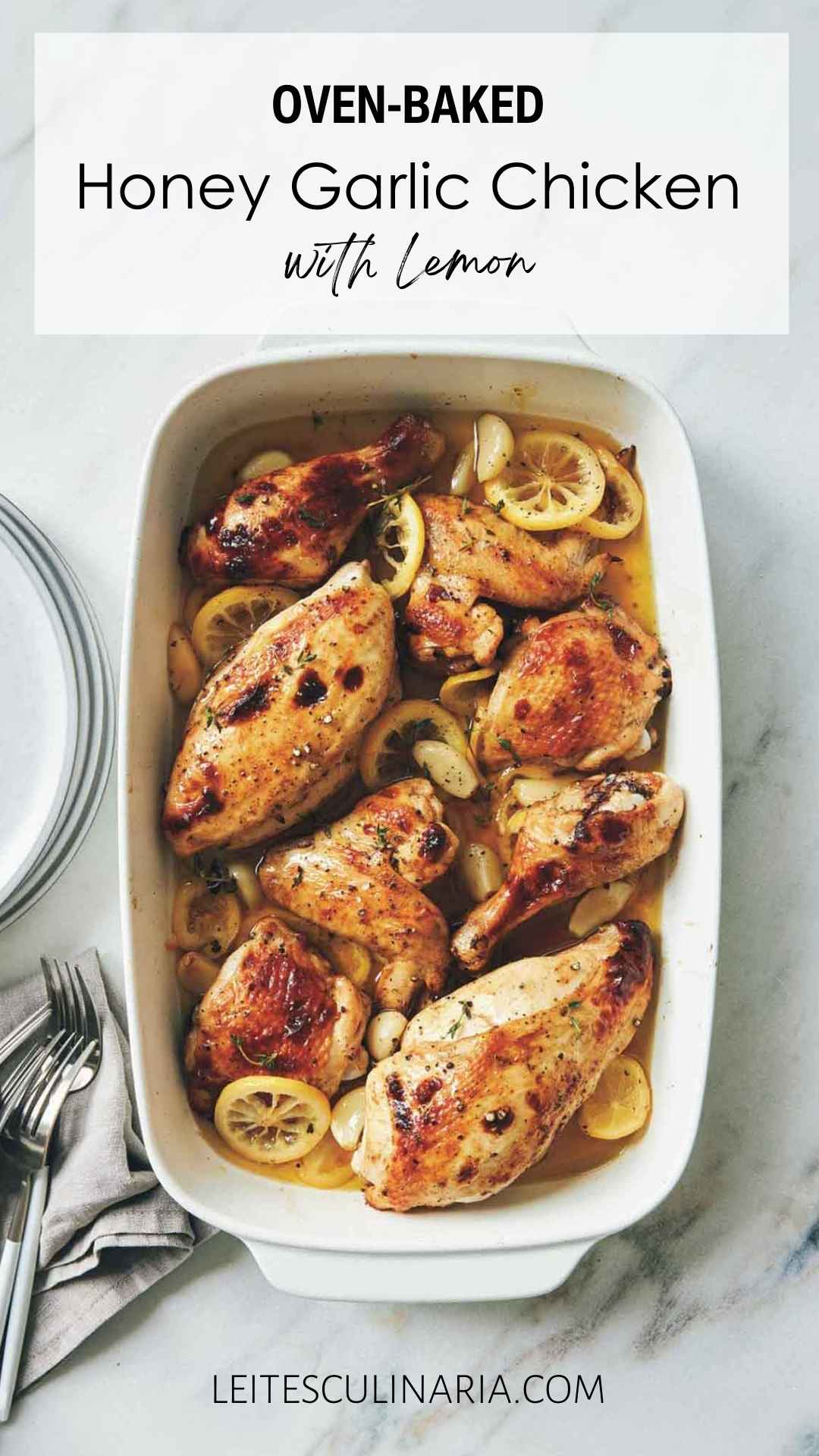 Pieces of honey glazed chicken in a white casserole diesh surrounded by lemon and garlic confit.