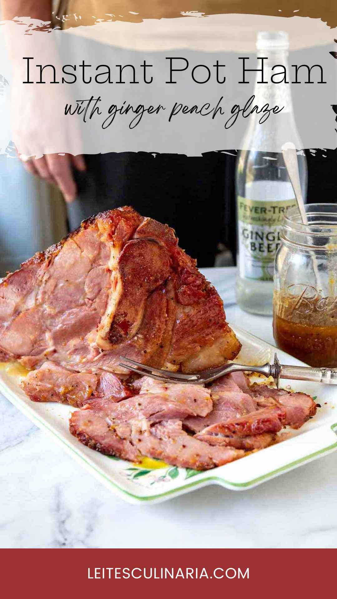 A partially carved Instant pot ham on a platter with a jar of glaze and bottle of ginger beer nearby.