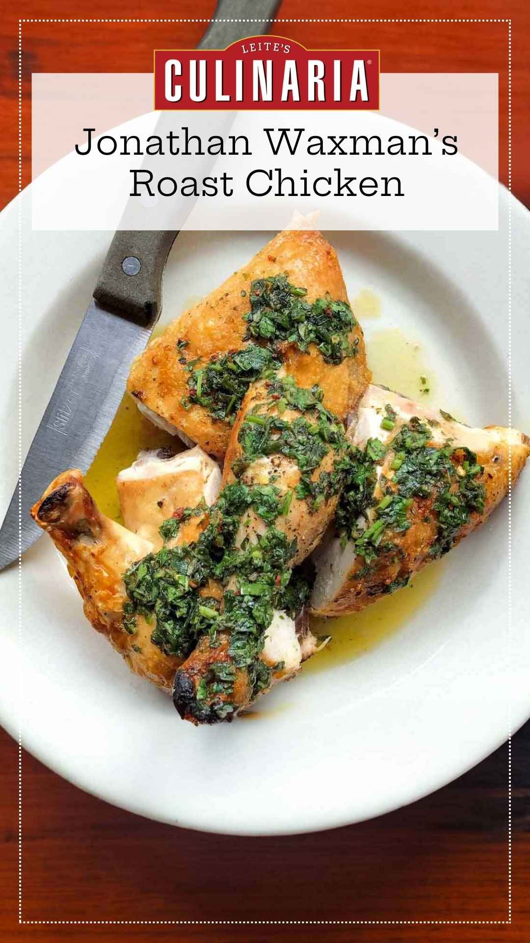 Pieces of roast chicken topped with salsa verde on a white plate, with a knife resting on the side.