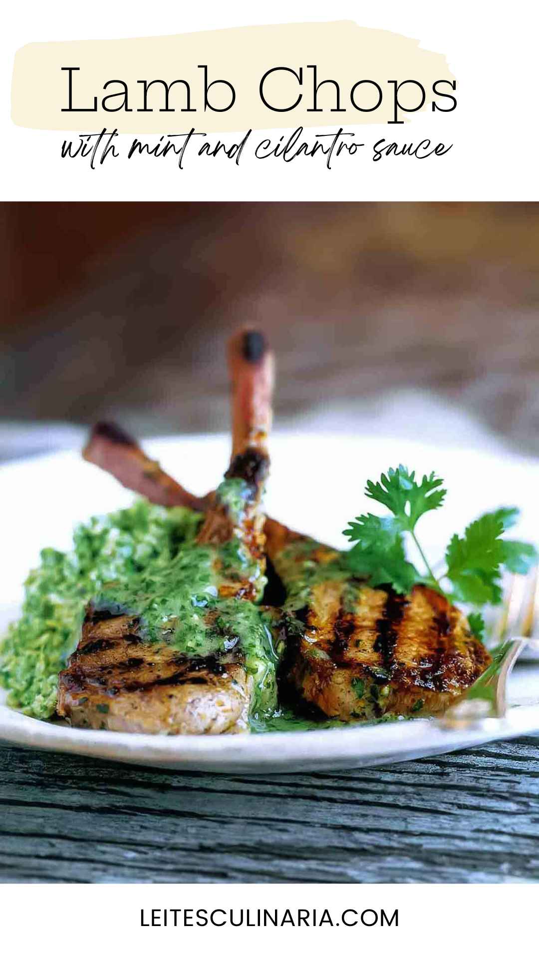Two grilled lamb chops topped with cilantro-mint sauce on a white plate.