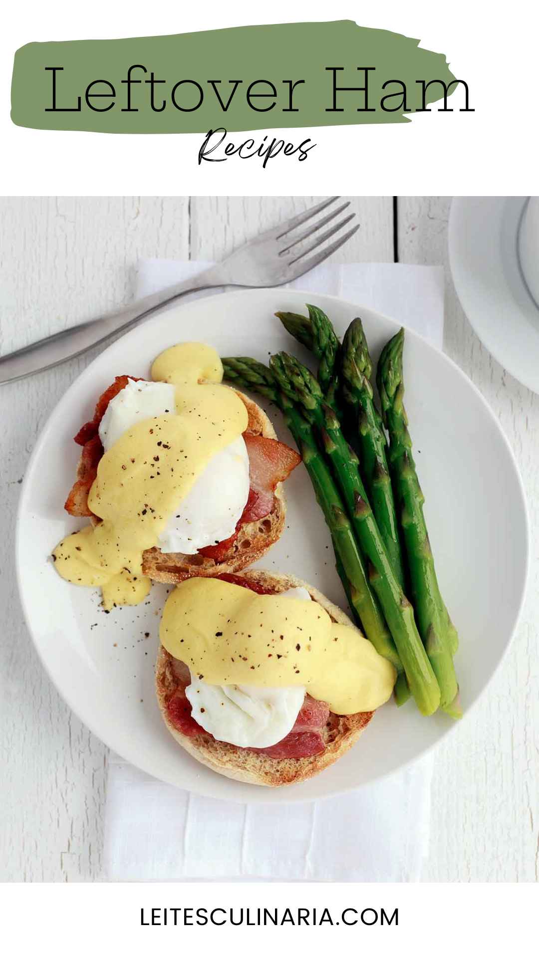 Two eggs Benedict topped with Hollandaise with asparagus on the side.