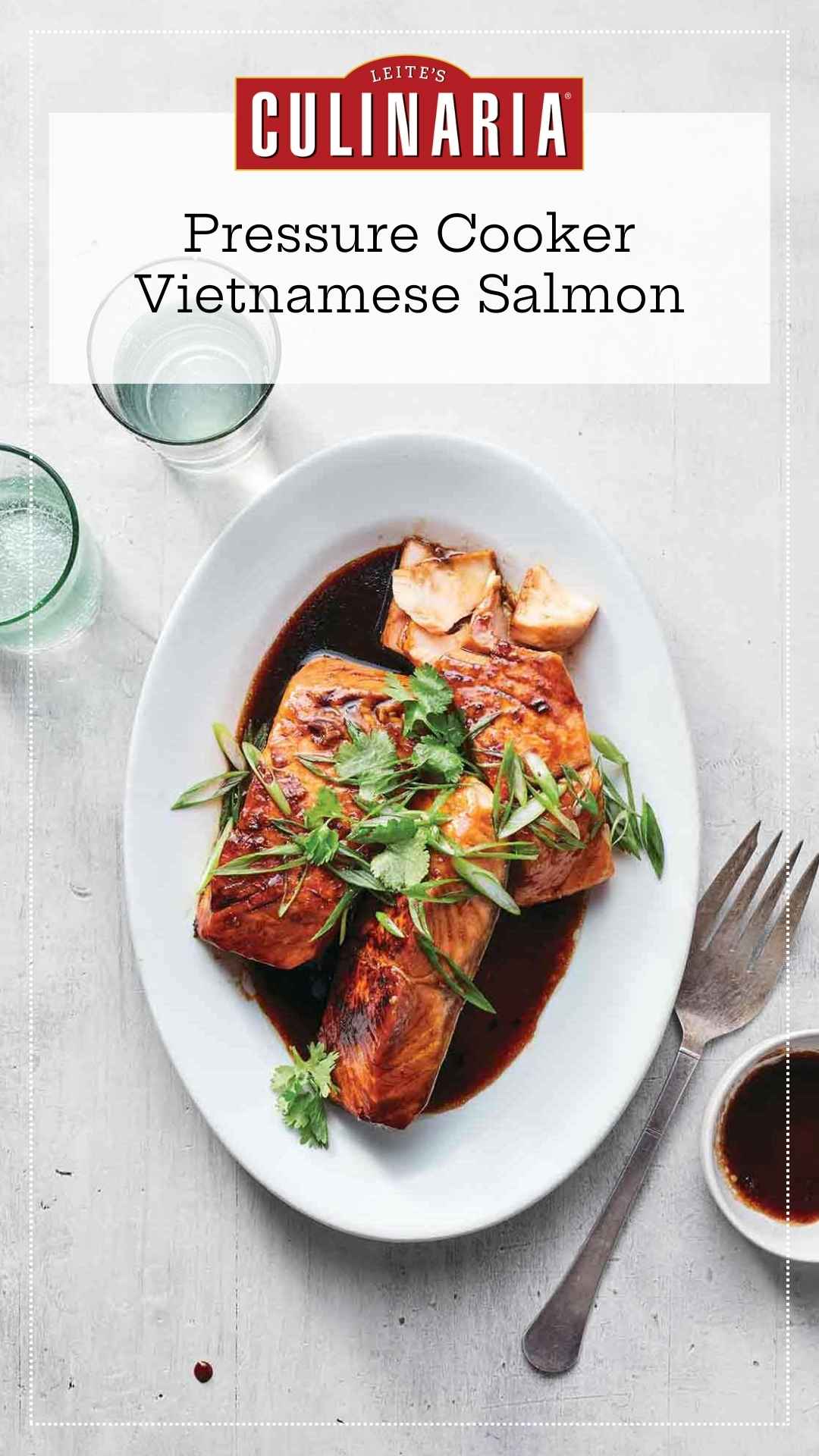 Three salmon filets on an oval platter in a soy caramel sauce, topped with cilantro and scallions.
