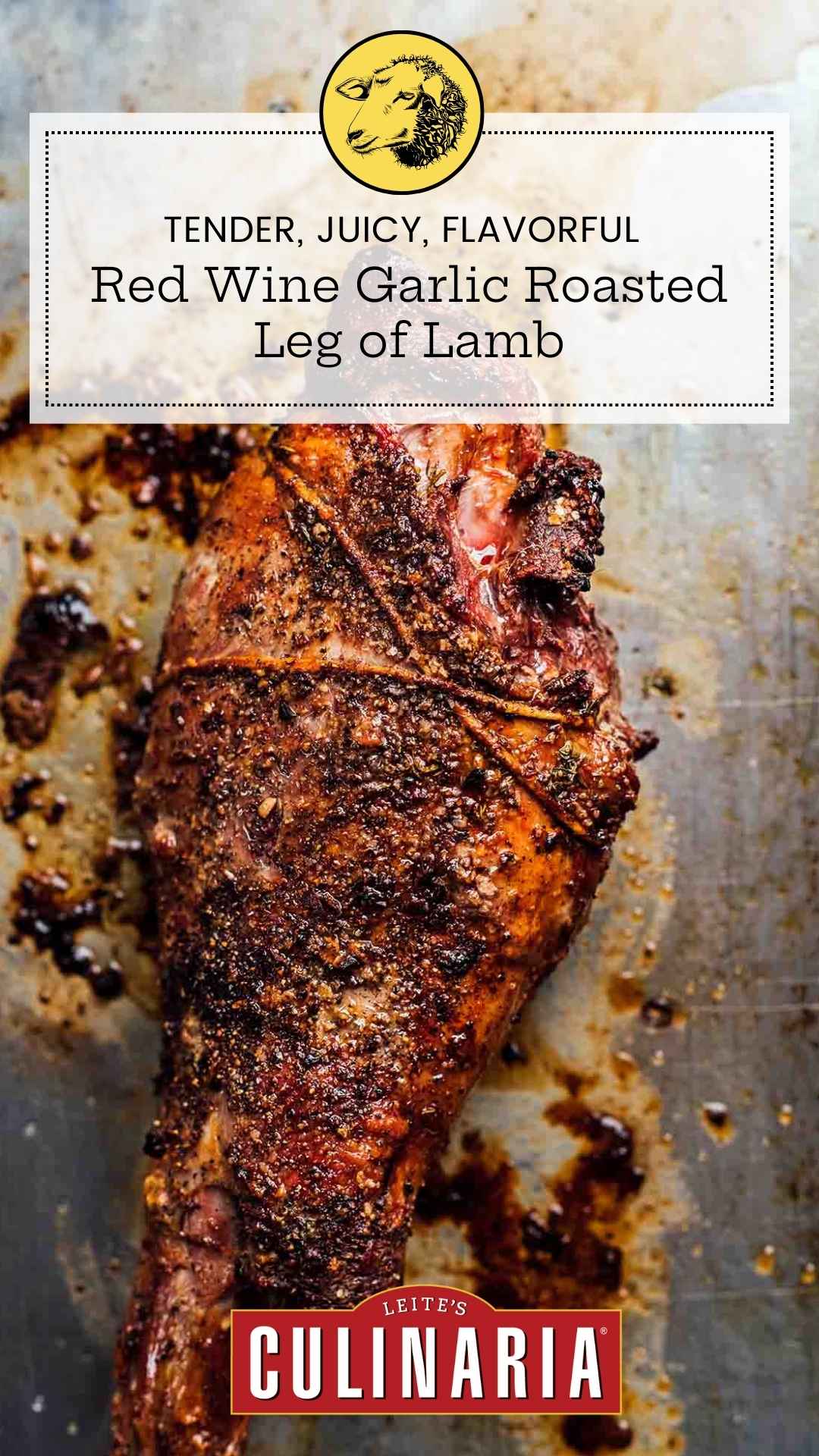 A whole roasted leg of lamb on a baking sheet with a garlic rub.