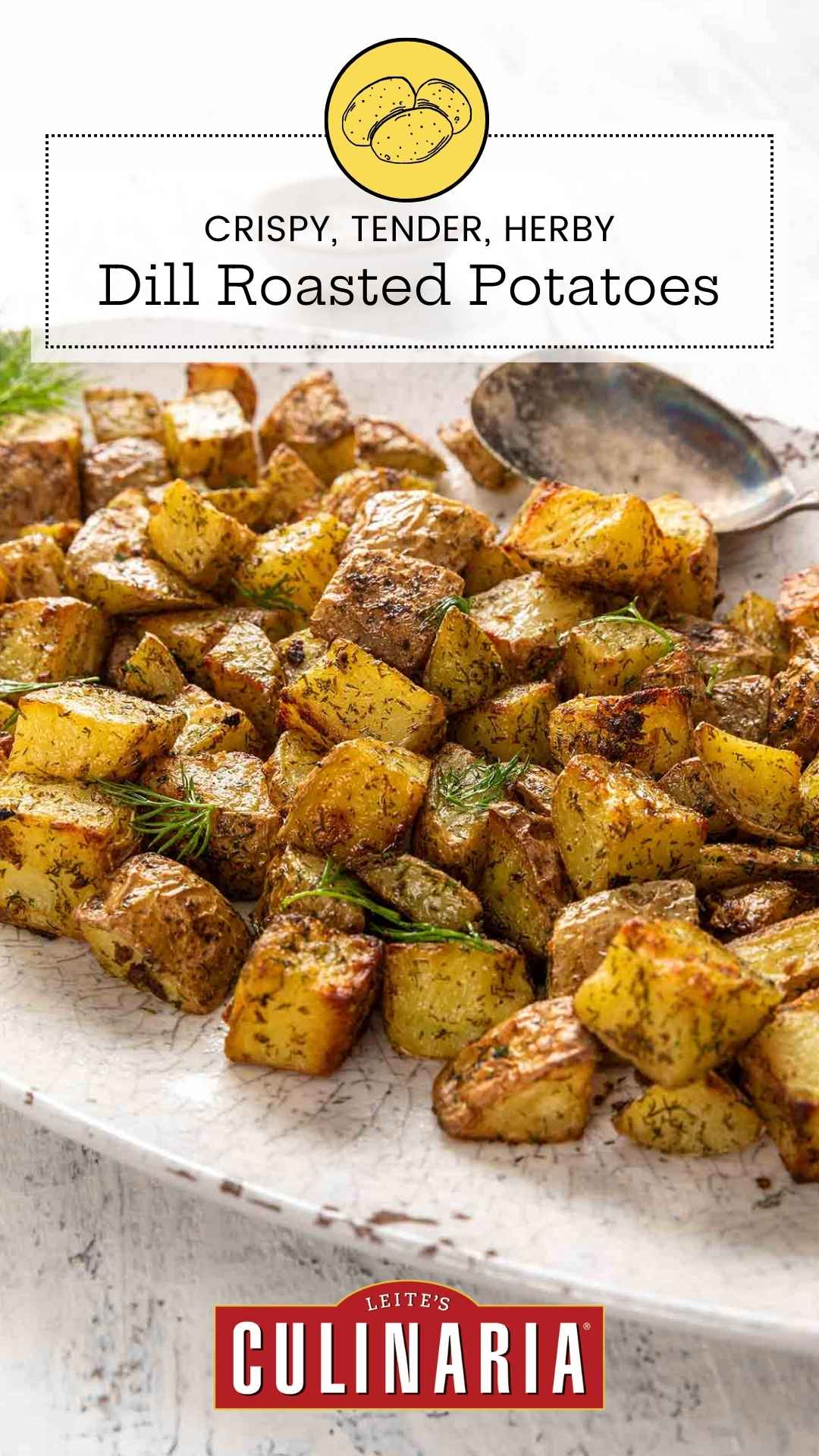 An oval platter filled with cubed roasted potatoes, garnished with fresh dill.