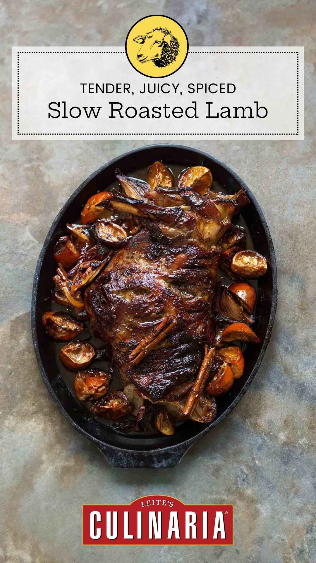 An oval baking dish filled with a slow roasted lamb shoulder, surrounded by orange wedges and cinnamon sticks.