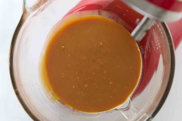 Caramel sauce inside a glass mixing bowl.
