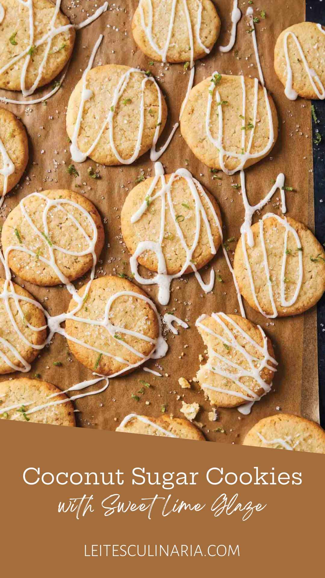 Several coconut lime cookies drizzled with glaze and sprinkled with lime zest on a wooden cutting board.