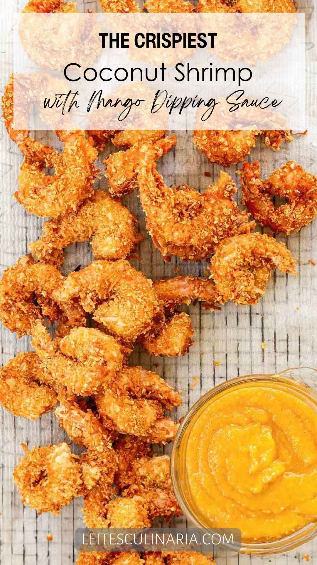 Crispy fried coconut shrimp on a wire rack with a bowl of yellow dipping sauce on the side.