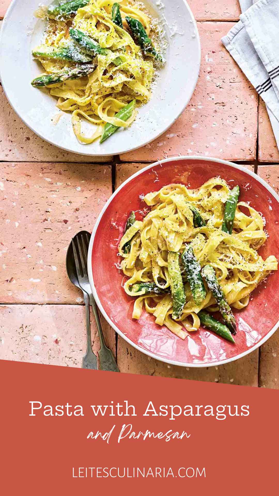 Two plates of creamy asparagus pasta topped with grated Parmesan cheese.