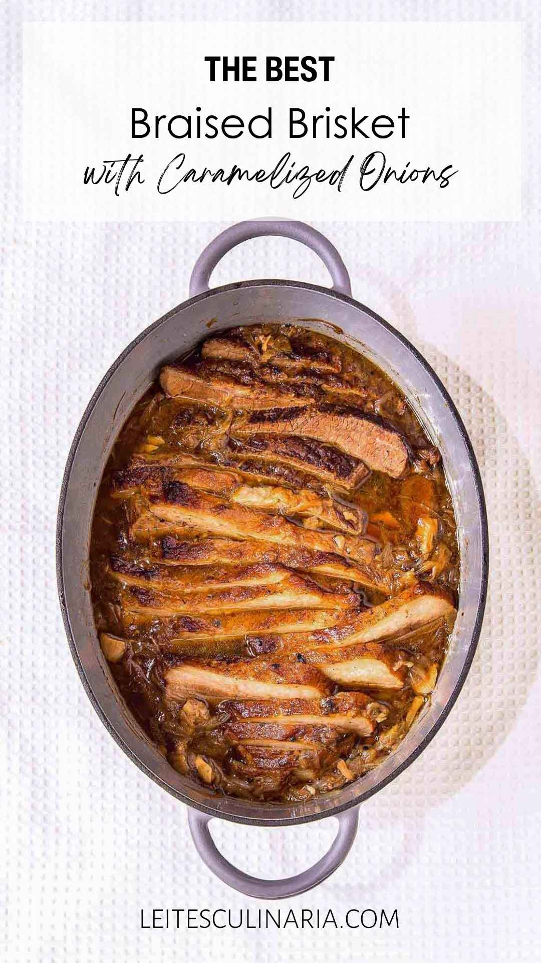 A sliced cooked French onion brisket inside a large oval Dutch oven.