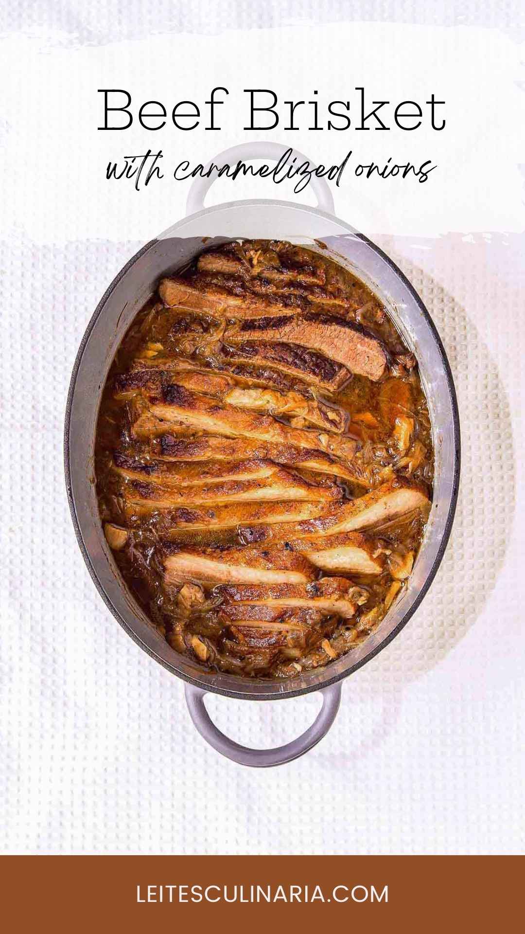A sliced cooked French onion brisket inside a large oval Dutch oven.