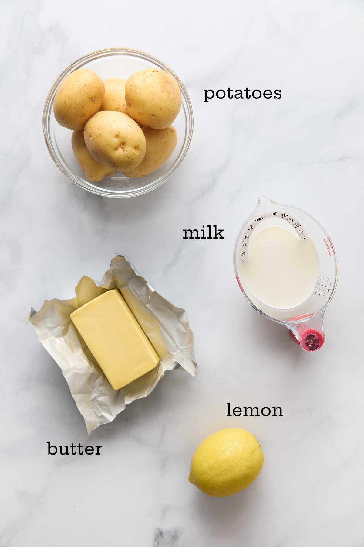 Ingredients for lemon mashed potatoes--potatoes, butter, milk, and lemon.