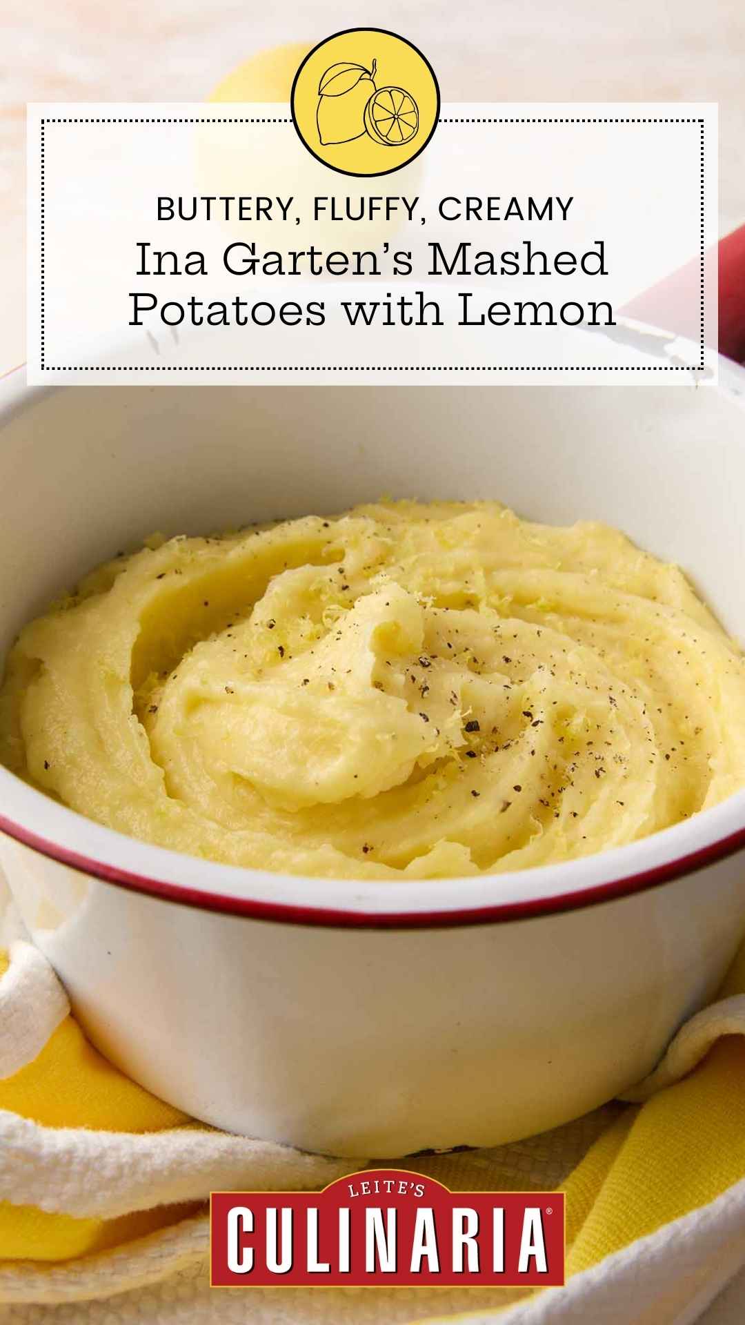 An enamel bowl filled with mashed potatoes, topped with black pepper and lemon zest.