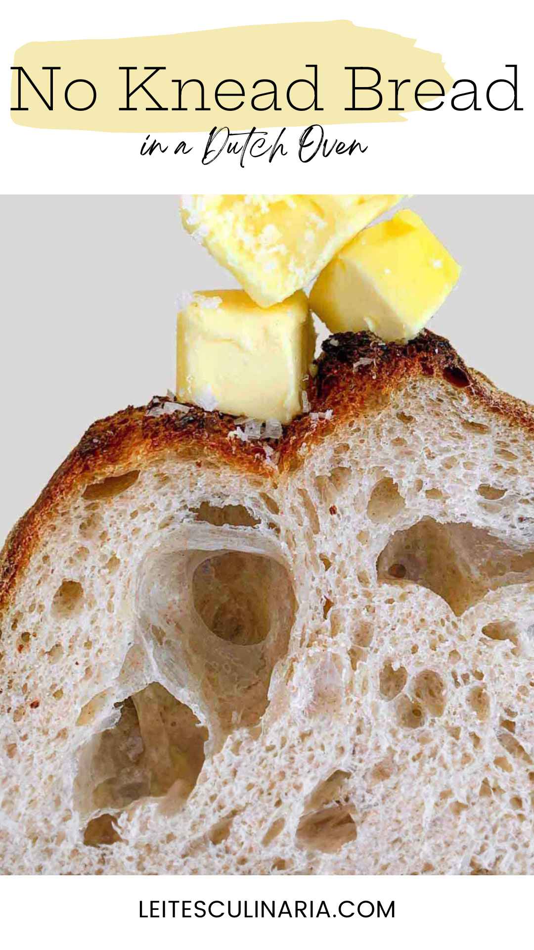 An interior view of a loaf of Jim Lahey's no-knead bread, topped with cubes of butter and flaked salt.
