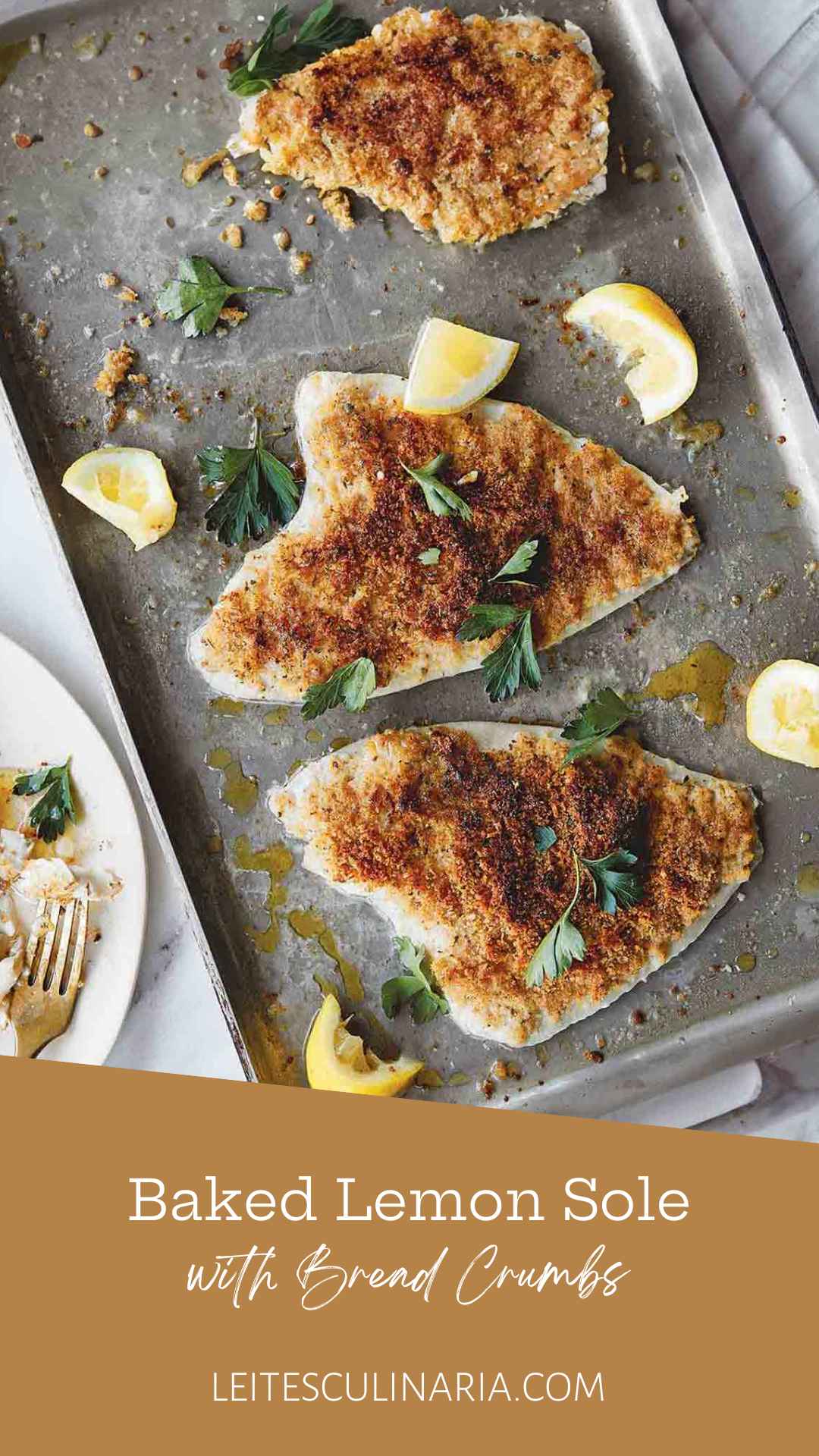 Three pieces of baked sole with bread crumbs and lemon on a rimmed baking sheet.