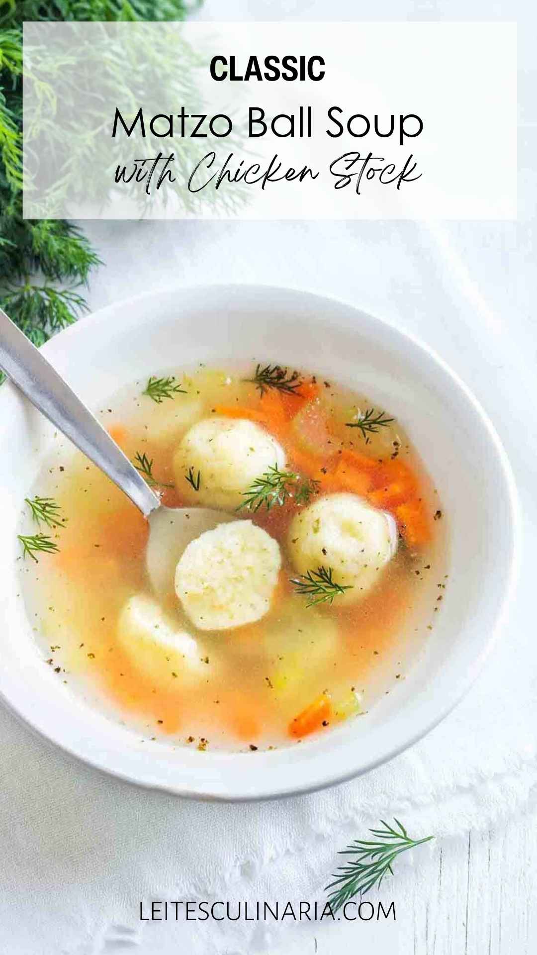 A bowl filled with matzo ball soup, garnished with fresh dill, and a spoon resting inside.