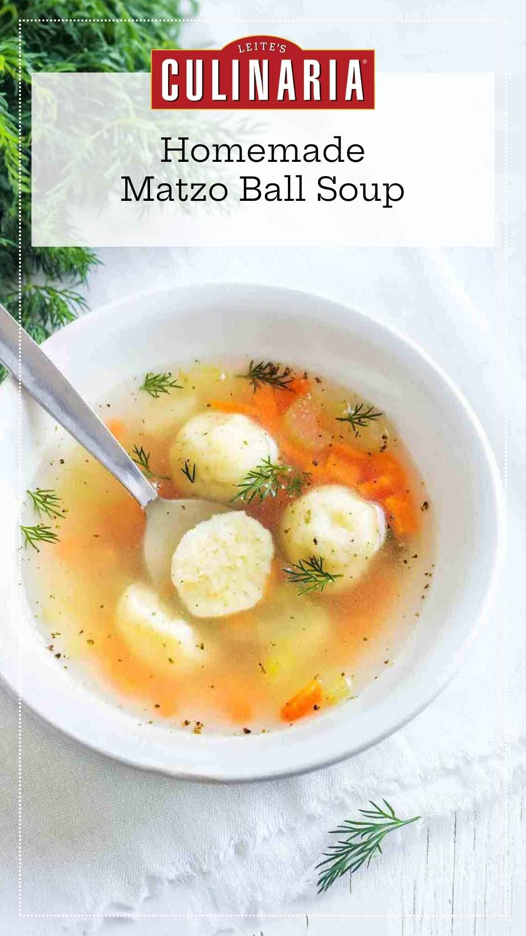 A bowl filled with matzo ball soup, garnished with fresh dill, and a spoon resting inside.