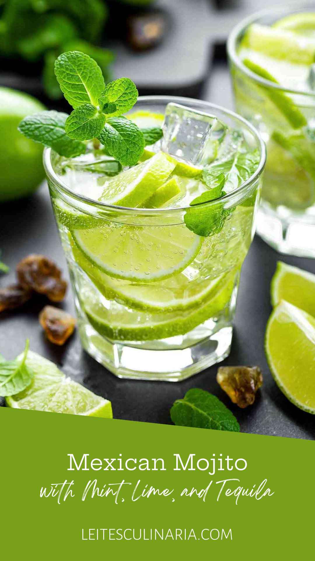 A highball glass filled with Mexican mojito, made with tequila, soda, lime slices, mint sprigs, and ice cubes.