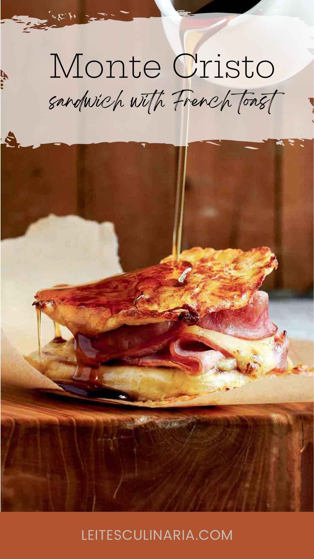 A Monte Cristo sandwich, made with French toast, ham, and Gruyère, with syrup being poured over it.