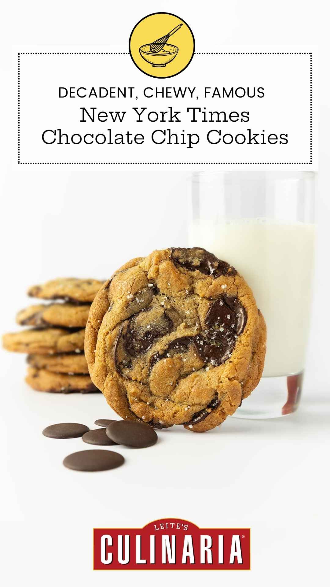 A chocolate chip cookie leaning against a glass of milk with several more stacked in the background.