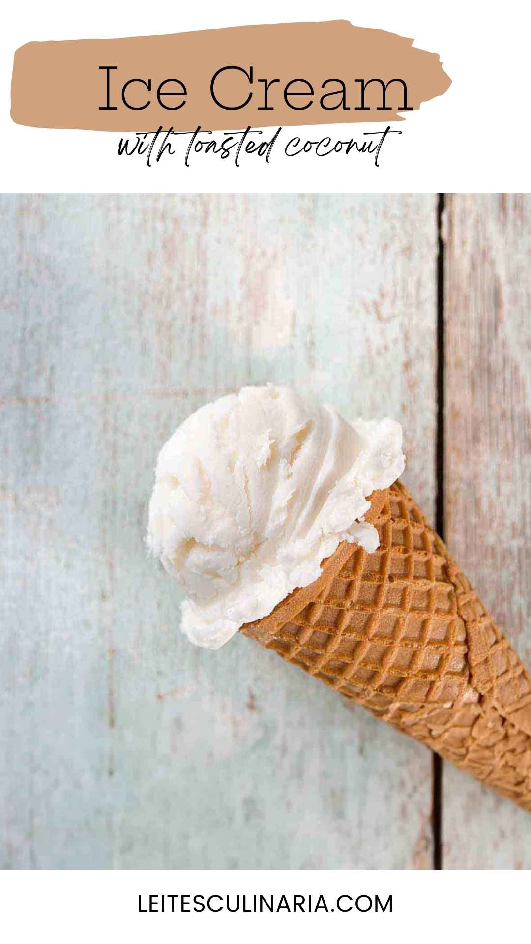 A waffle cone with a scoop of toasted coconut ice cream in it.