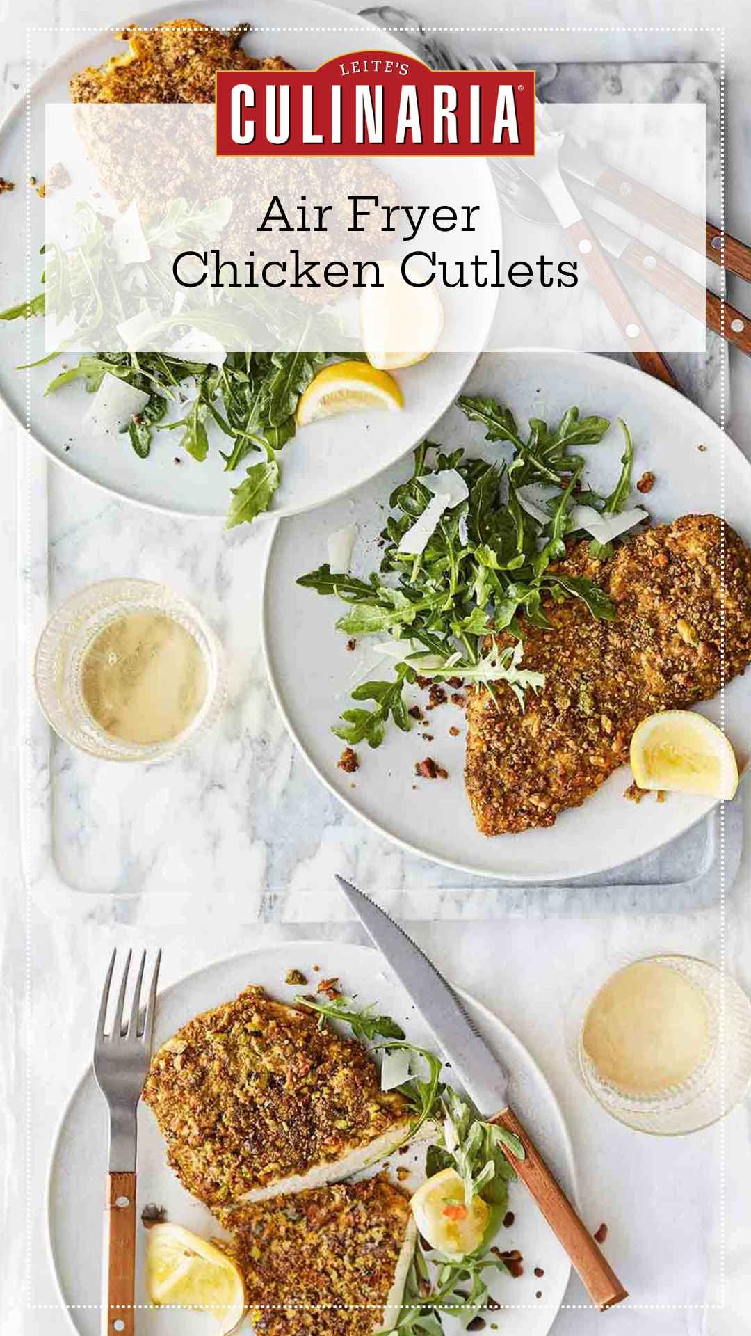 Three plates with a pistachio-crusted chicken cutlet, a lemon wedge, and an arugula and Parmesan salad on each one.