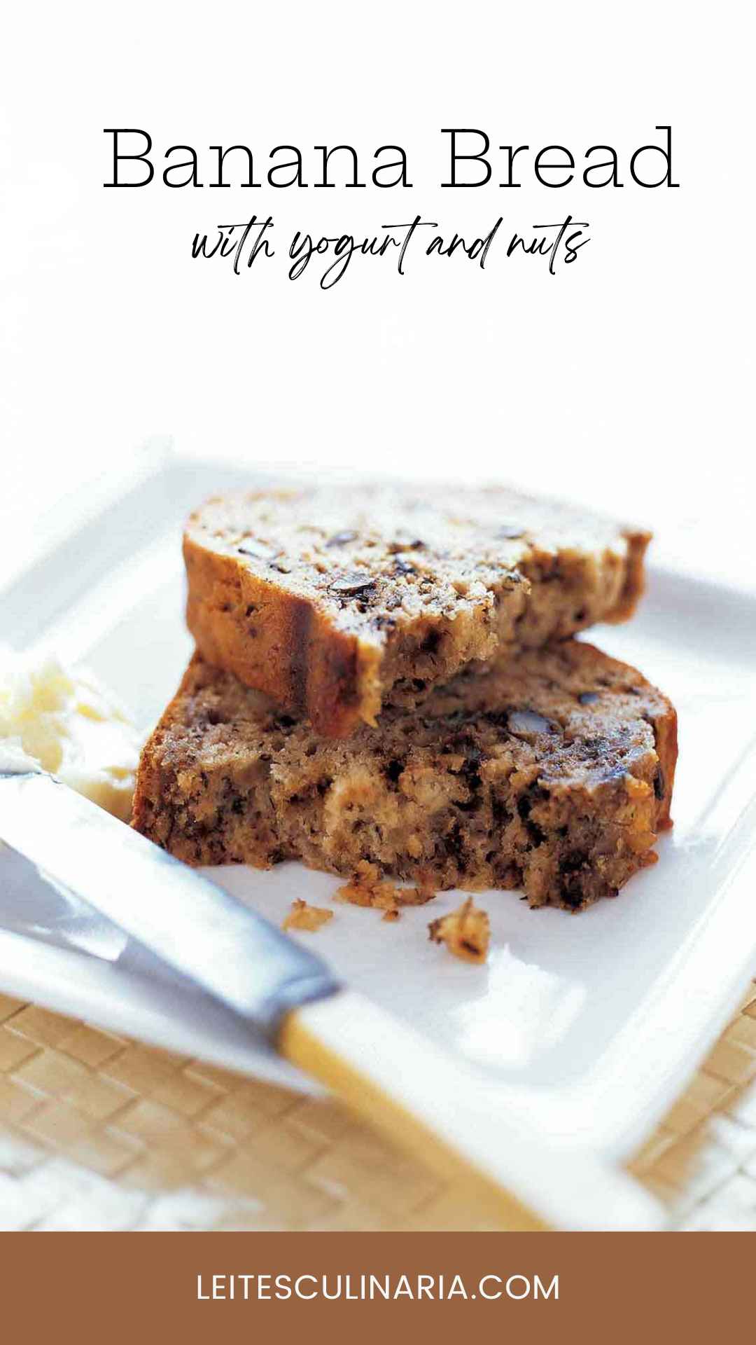 A piece of banana bread broken in half and the halves stacked on top of each other on a white plate.
