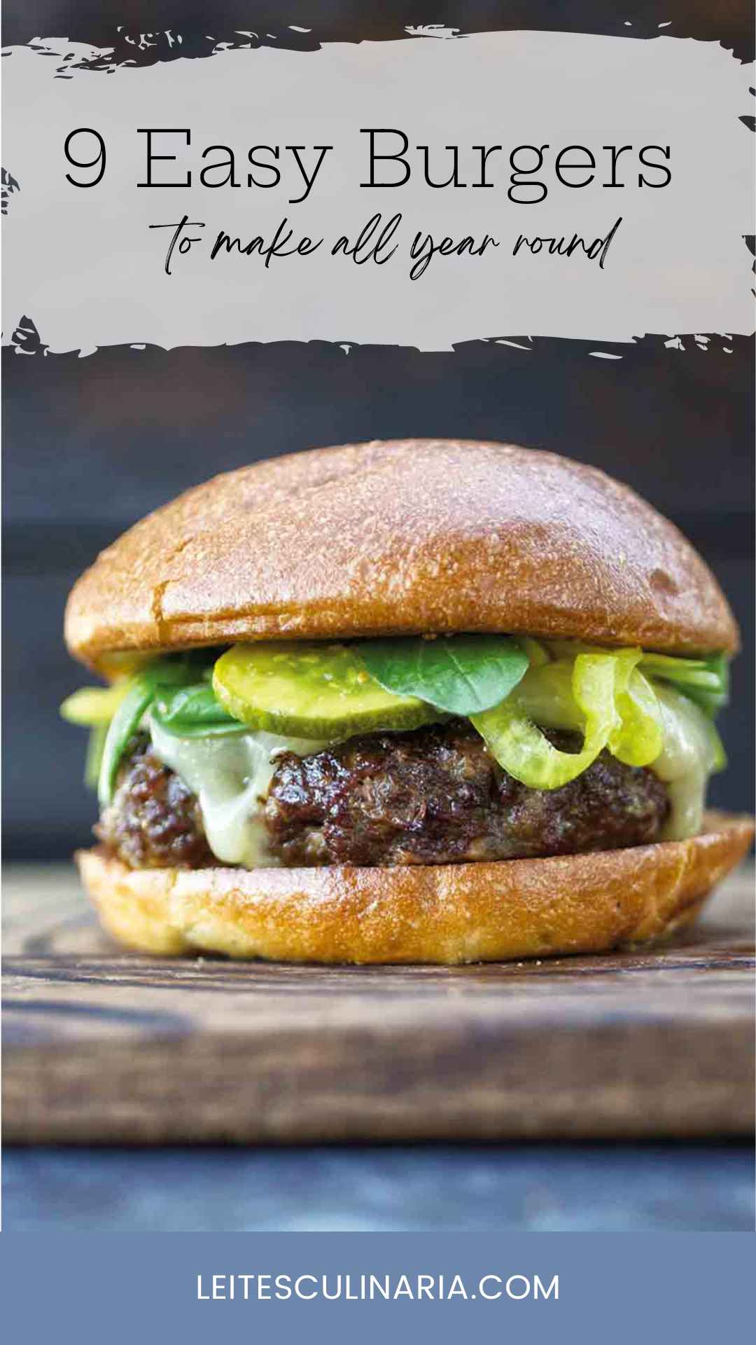 A burger topped with cheese, spinach, and pickles.