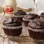 Chocolate muffins cooling on a wire rack.