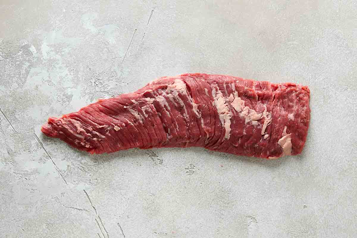 An uncooked piece of skirt steak.