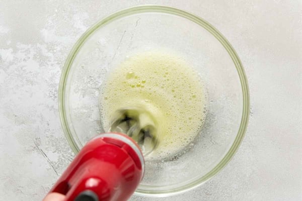 A mixer beating egg whites until foamy.