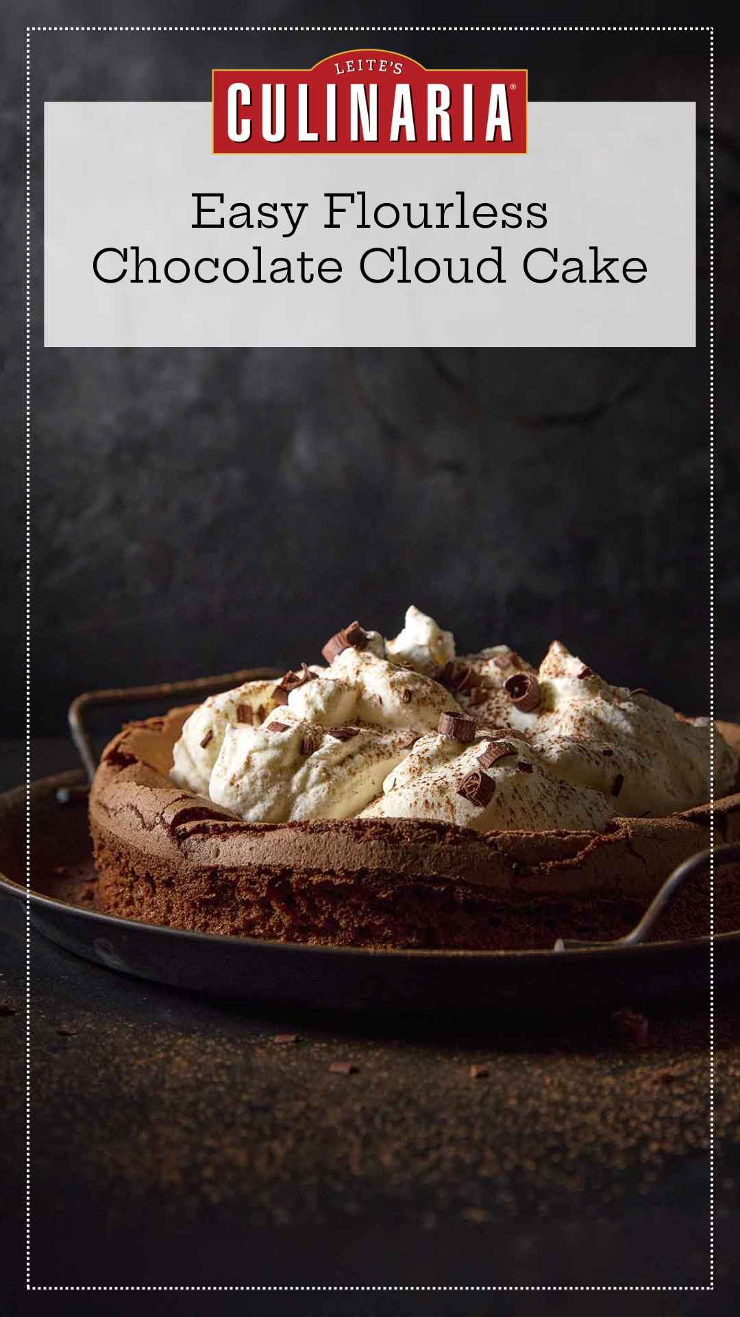 A flourless chocolate cloud cake topped with billows of whipped cream on a metal platter.