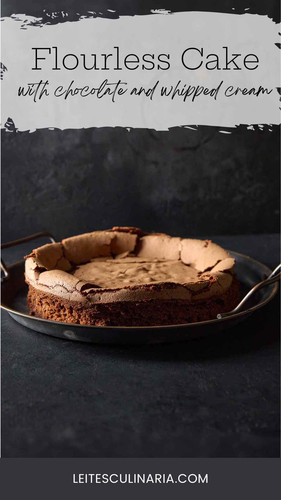 A flourless chocolate cloud cake with a sunken middle on a metal platter.