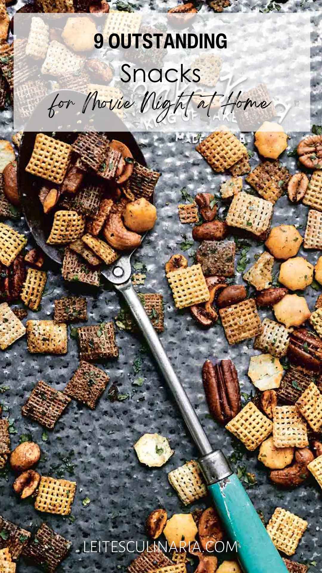 A tray of Chex mix with a large spoon in the middle.