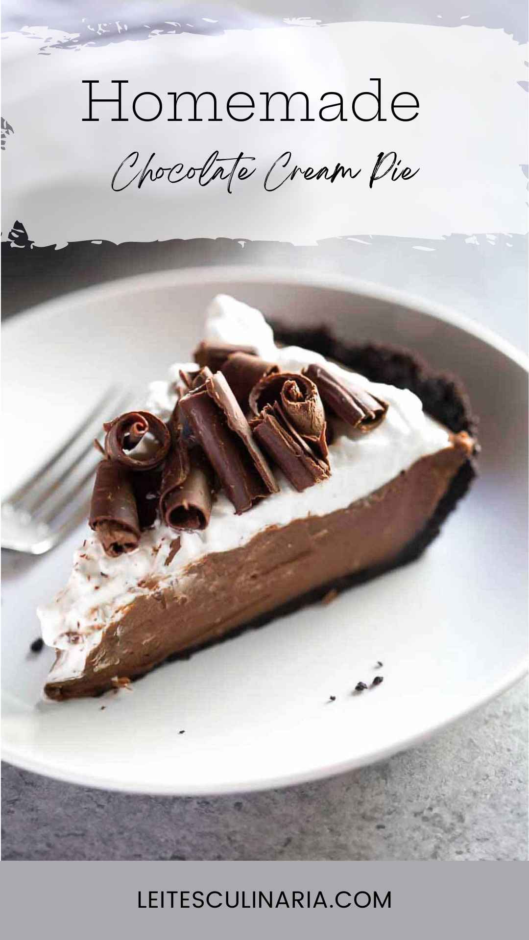A slice of chocolate cream pie with Oreo crust topped with chocolate curls on a white plate.