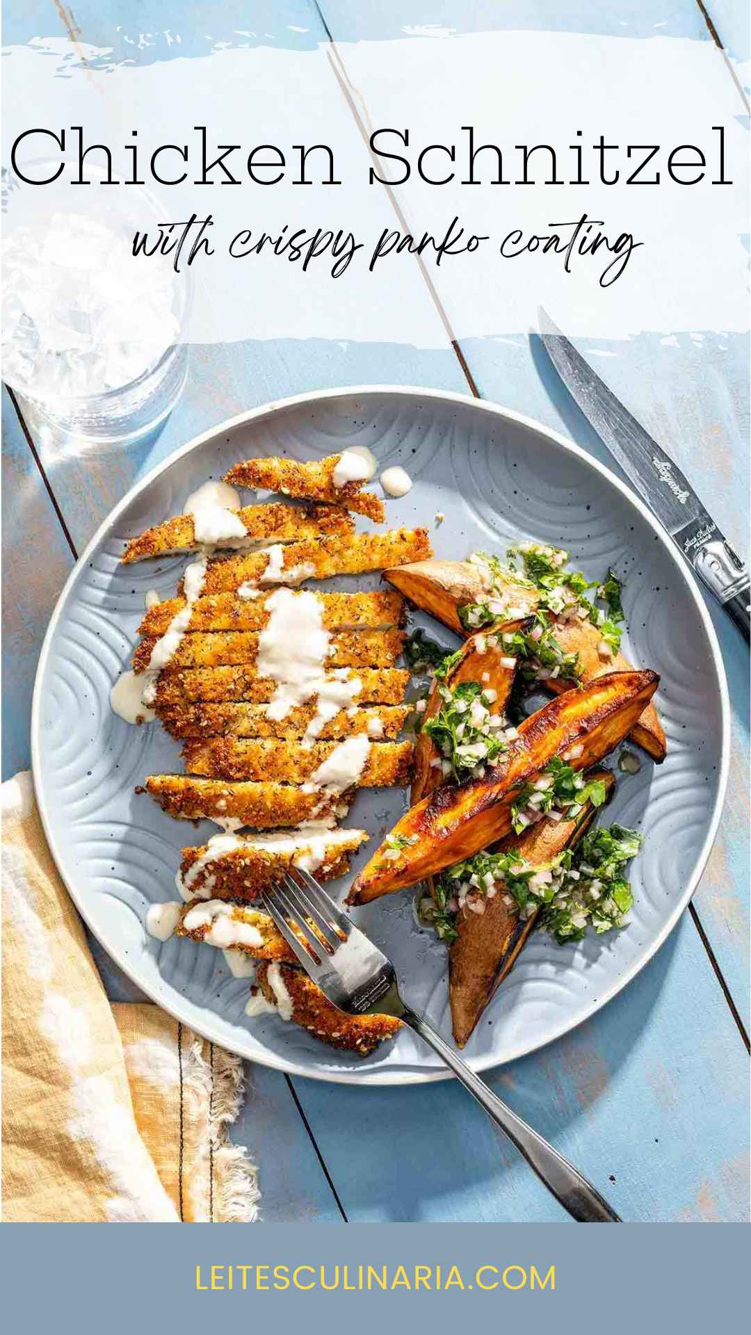 A sliced chicken cutlet with panko coating on a plate with sweet potato wedges and a vinaigrette dressing.