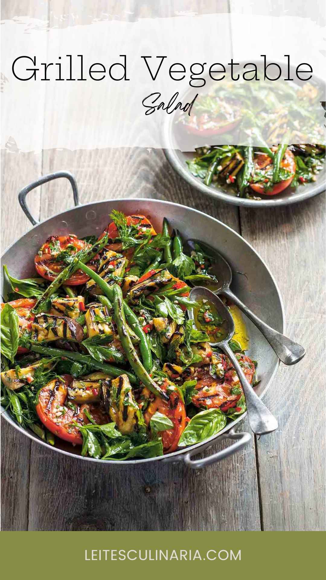 A large metal bowl filled with grilled zucchini, beans, tomatoes, and fresh basil.