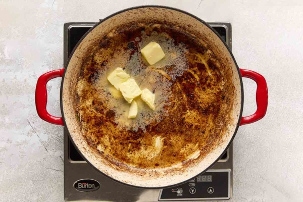 Butter melting in a cast iron skillet.