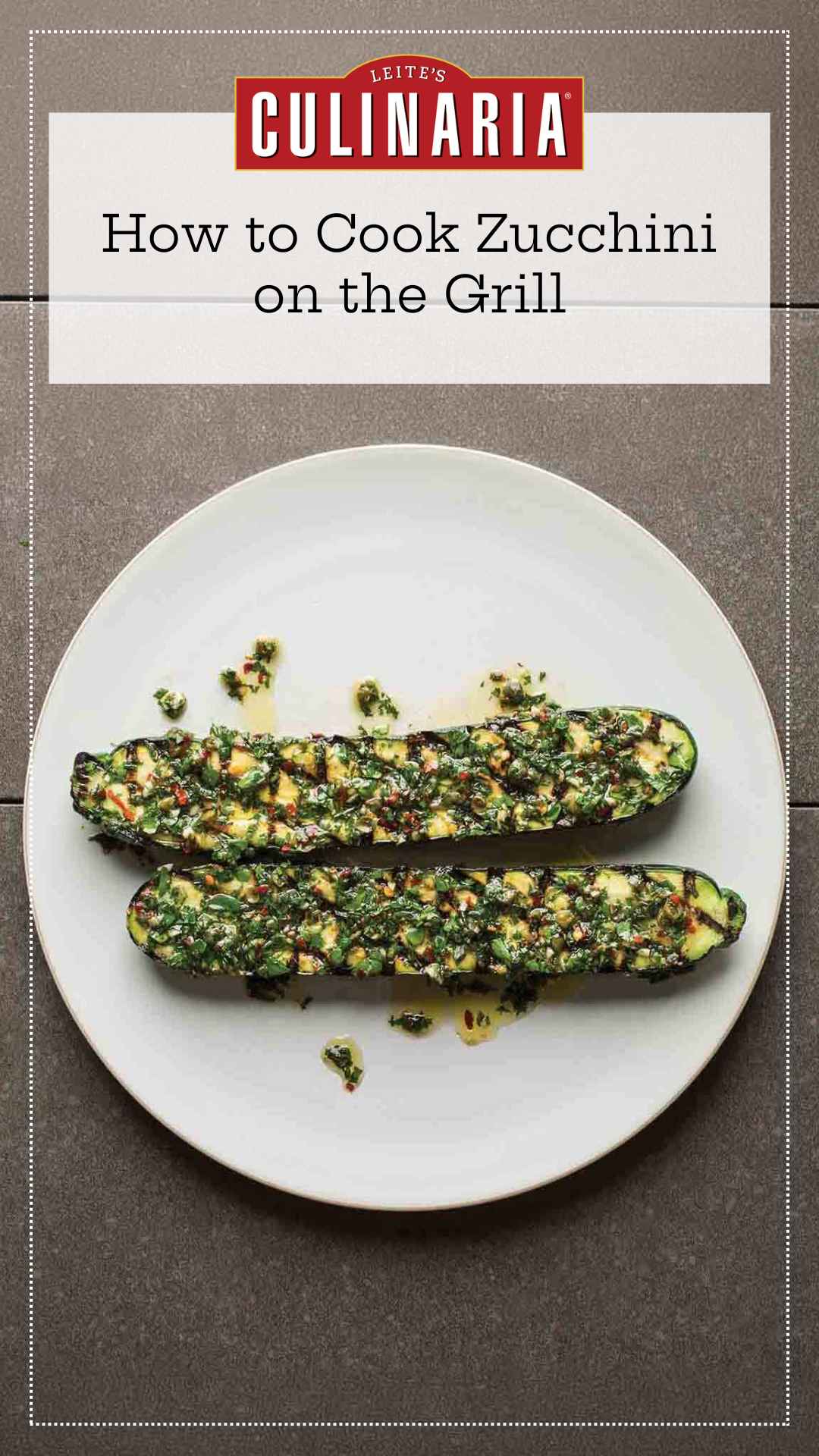 Two grilled zucchini halves topped with mint salsa on a white plate.
