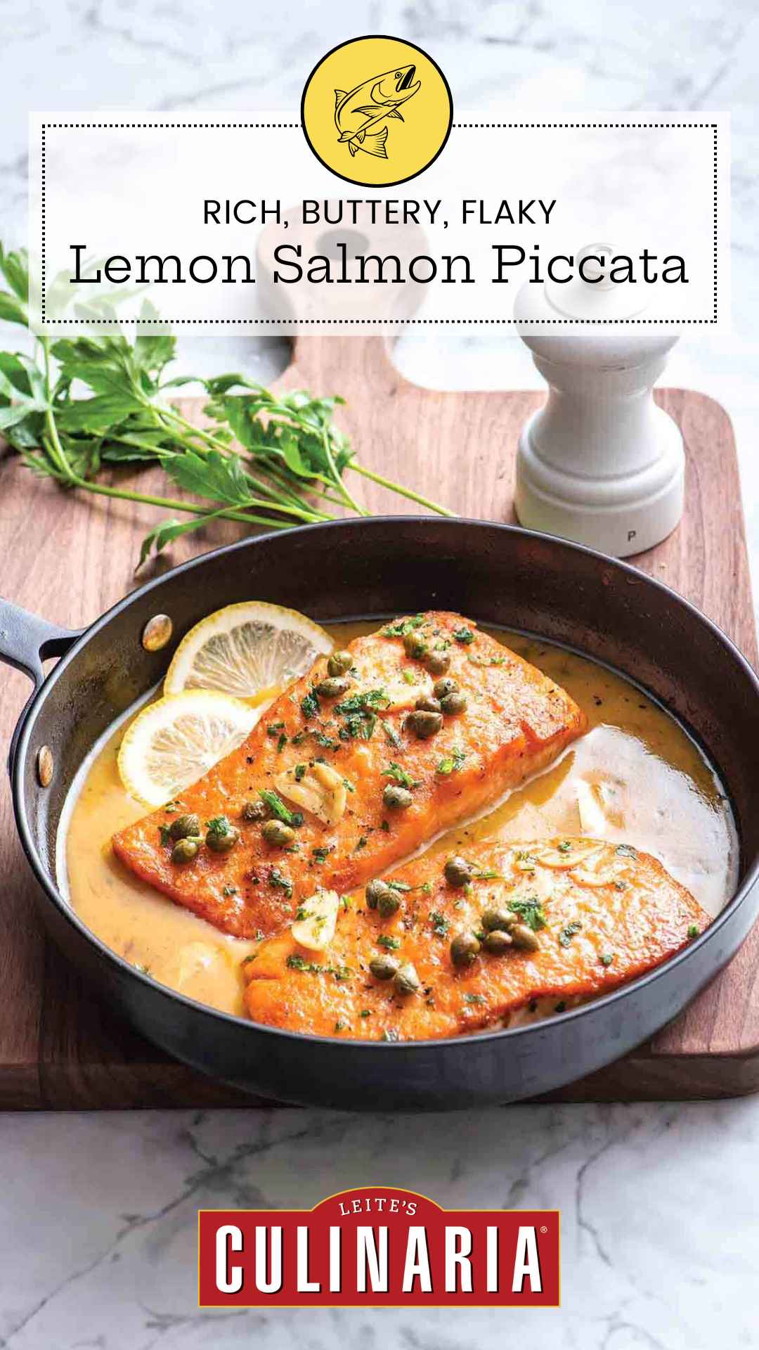 Two salmon fillets in a skillet with sliced lemons, capers and butter sauce.