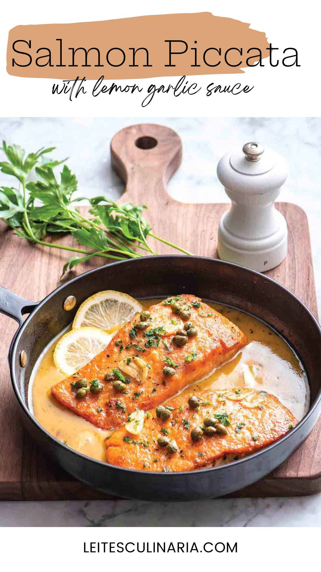 Two salmon fillets in a skillet with sliced lemons, capers and butter sauce.