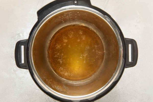 Liquid in the bottom of an Instant Pot.