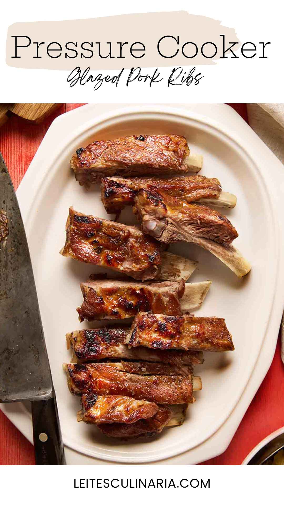 A platter of pressure cooker ribs cut into individual ribs, with a carving knife on the side.